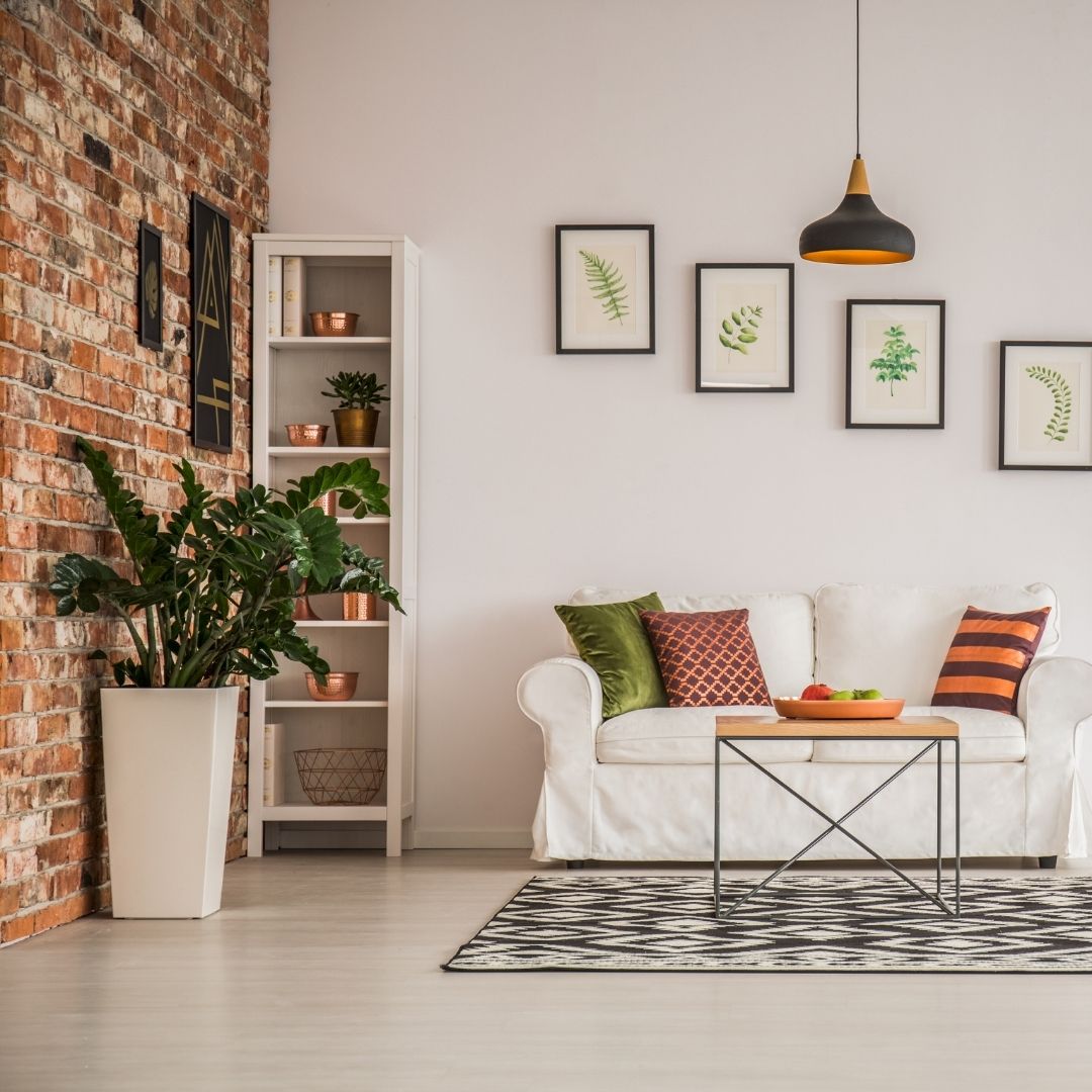 living room with red brick wall