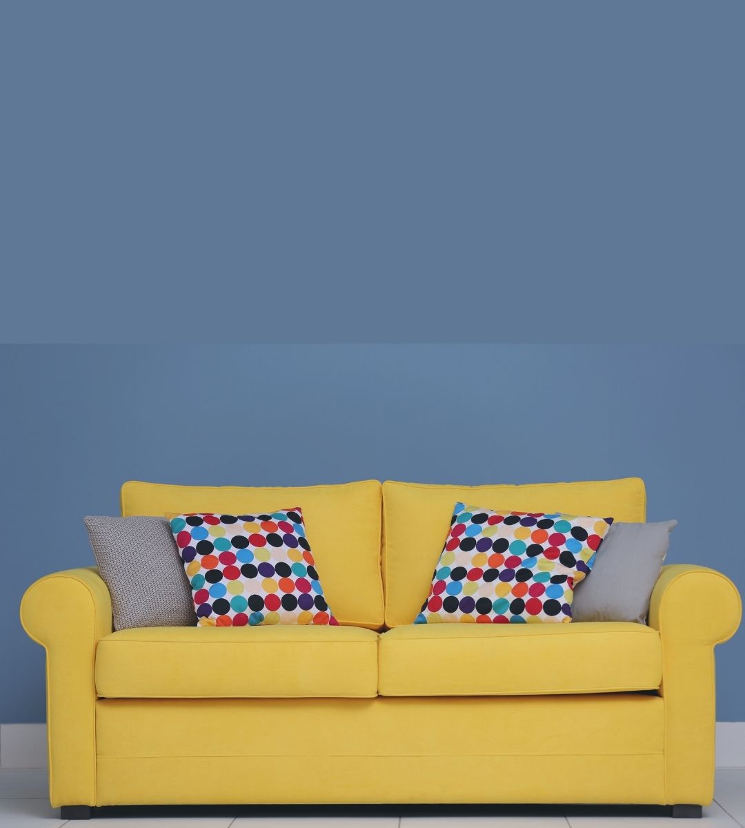 yellow sofa and colorful throw pillow