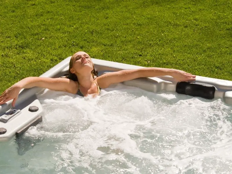 woman relaxing in outdoor hot tub